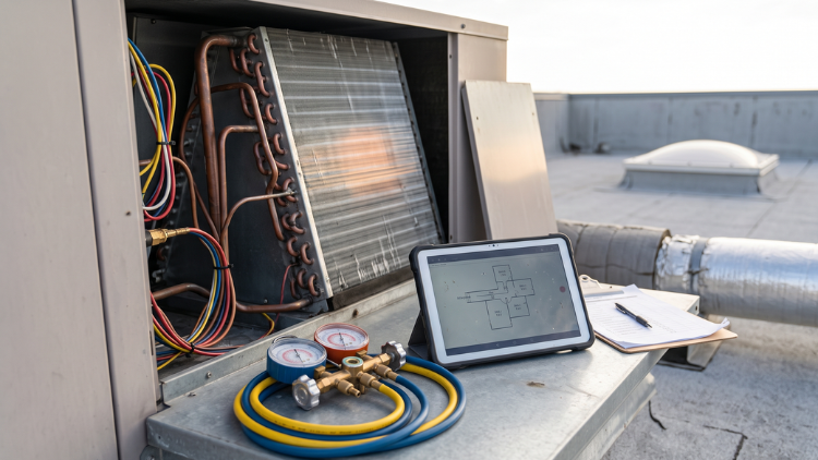 AC unit with exposed coils and refrigerant gauges connected